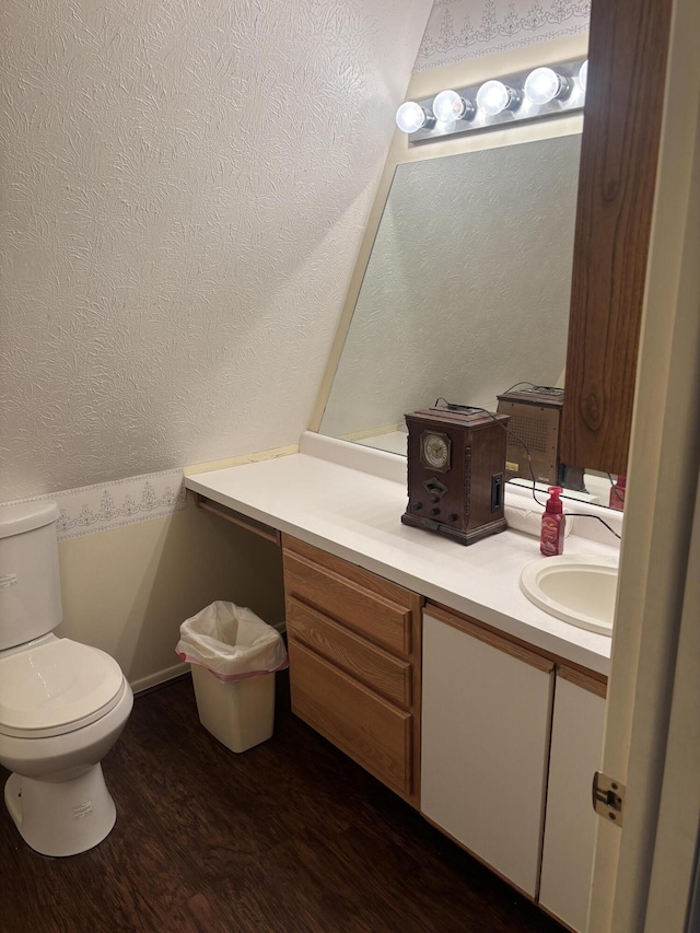 bathroom with wood finished floors, vanity, and toilet