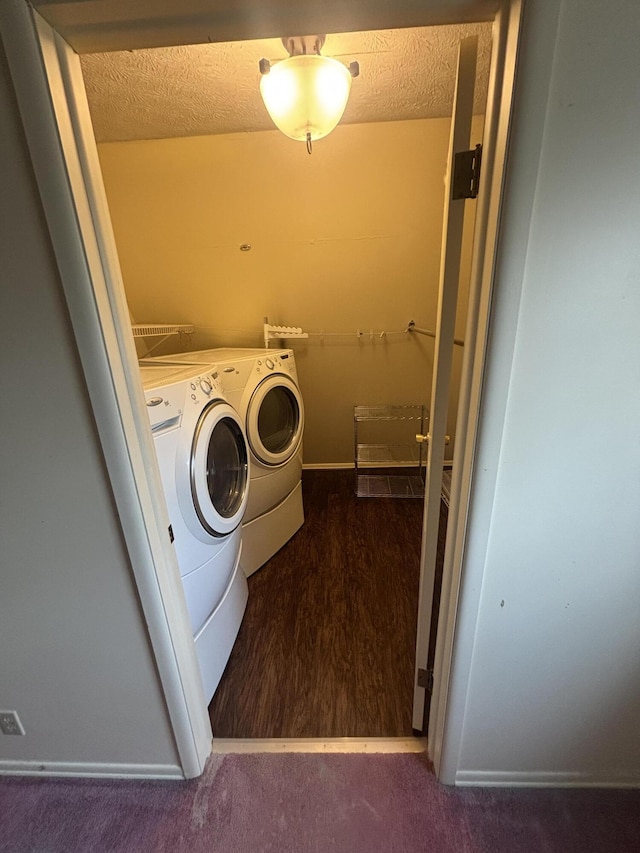 laundry area featuring separate washer and dryer, carpet floors, a textured ceiling, and laundry area