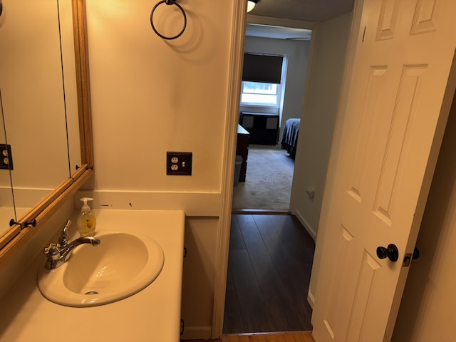 1008 Manor Ln Unit C, Columbus, OH 43221 - bathroom featuring baseboards, wood finished floors, and vanity