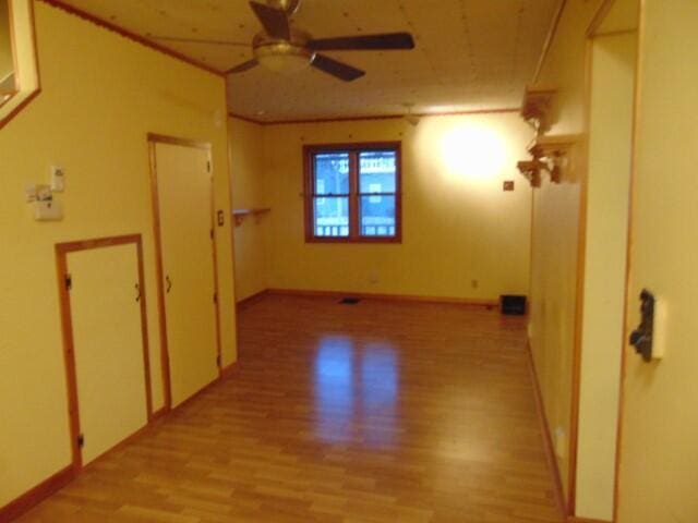 unfurnished room with ceiling fan and light wood-type flooring