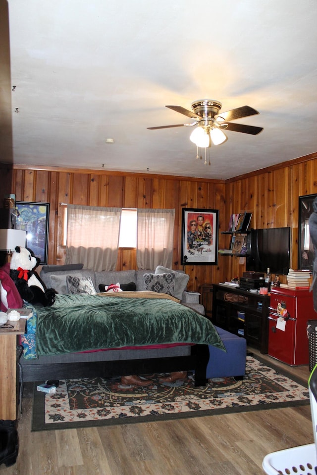 bedroom with wood walls and wood finished floors