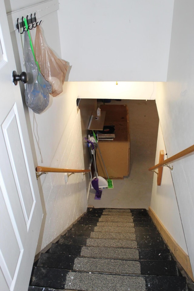 staircase featuring baseboards