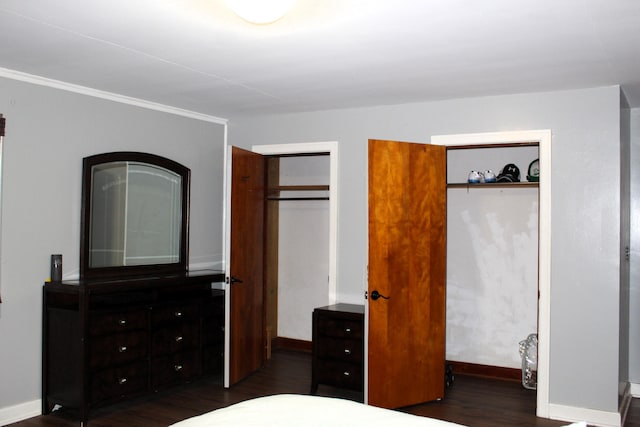 bedroom with baseboards and wood finished floors