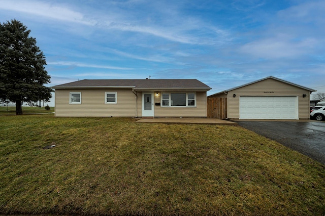 ranch-style home featuring a garage and a front lawn