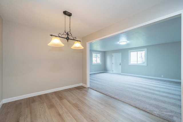 empty room with light hardwood / wood-style flooring