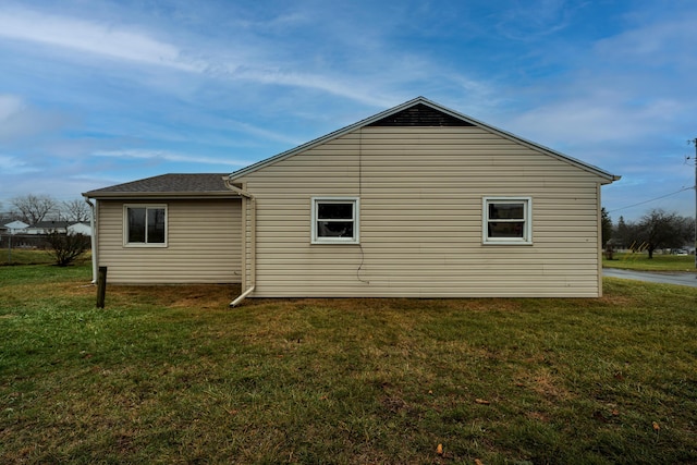 view of side of property with a lawn