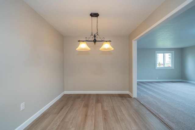 spare room featuring light hardwood / wood-style flooring