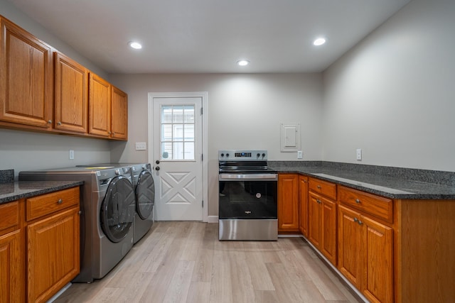 washroom with light hardwood / wood-style floors and washing machine and dryer