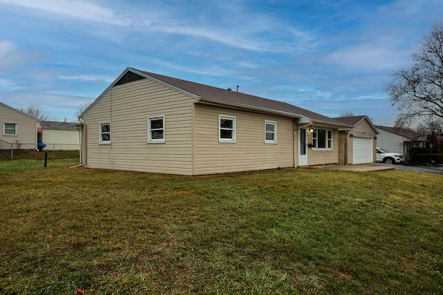 view of property exterior featuring a garage and a yard