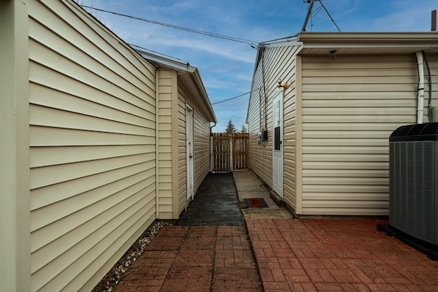 view of side of home featuring cooling unit and a patio area