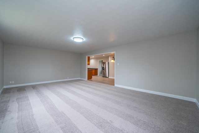 unfurnished room with light carpet