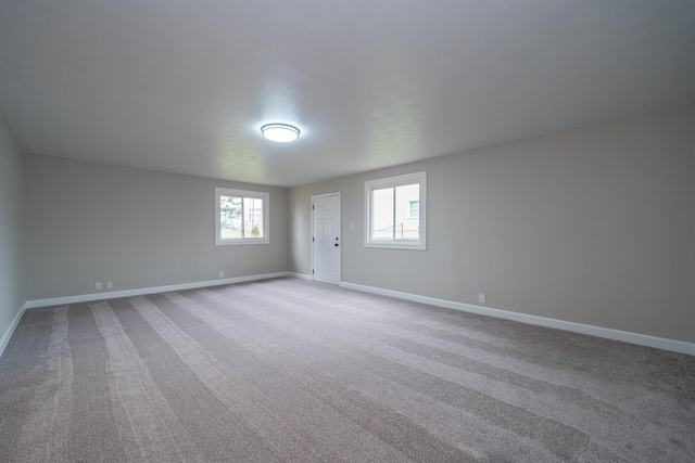 spare room featuring light colored carpet