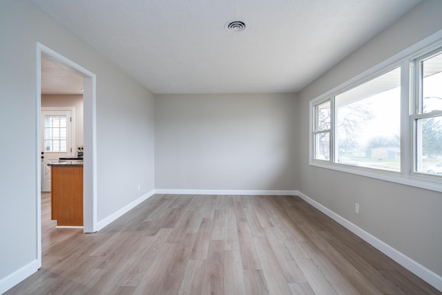 spare room with light wood-type flooring