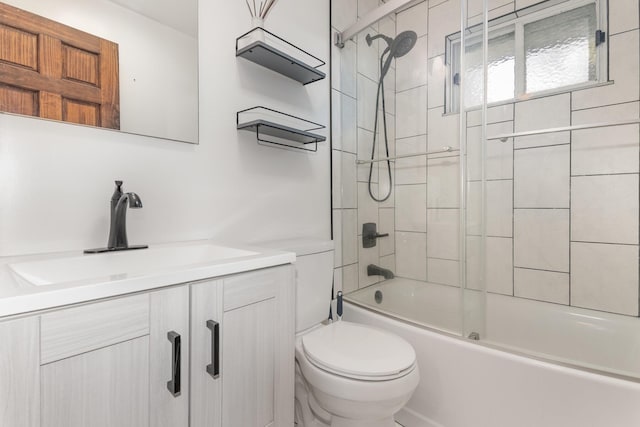 bathroom with toilet, vanity, and enclosed tub / shower combo