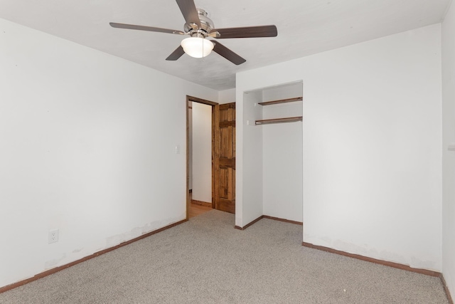 unfurnished bedroom with baseboards, a closet, carpet, and a ceiling fan