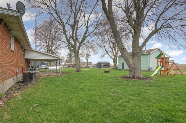 view of yard featuring a playground and central air condition unit