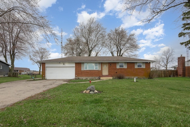 single story home featuring driveway, brick siding, a garage, and a front yard