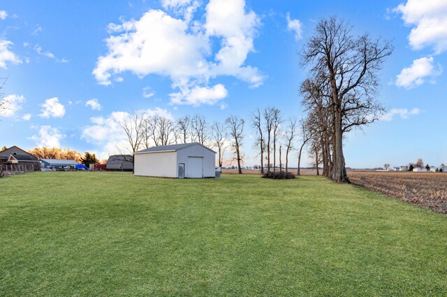 view of yard with an outdoor structure, a garage, and a pole building