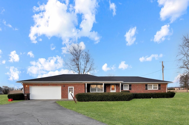 ranch-style home with concrete driveway, a garage, brick siding, and a front yard