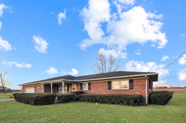 single story home with a front lawn, brick siding, and a garage