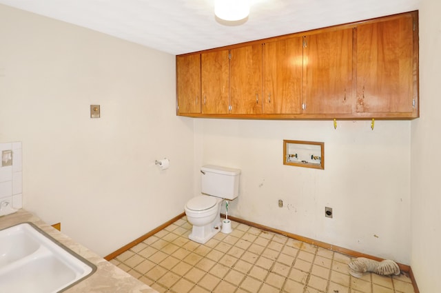 washroom featuring baseboards, laundry area, hookup for a washing machine, electric dryer hookup, and a sink