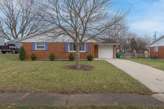 ranch-style house with central AC, a garage, and a front yard