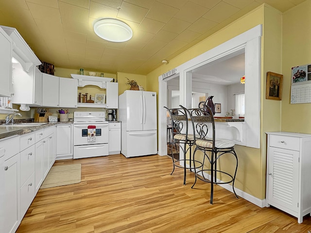 kitchen with white cabinetry, sink, white appliances, and light wood-type flooring