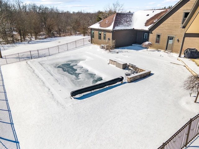 snow covered pool with fence