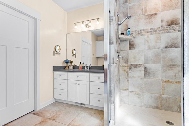 bathroom featuring tile patterned flooring, visible vents, vanity, and a shower stall