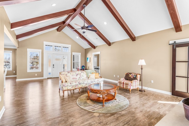 living room with high vaulted ceiling, a barn door, dark wood-style flooring, a ceiling fan, and beamed ceiling