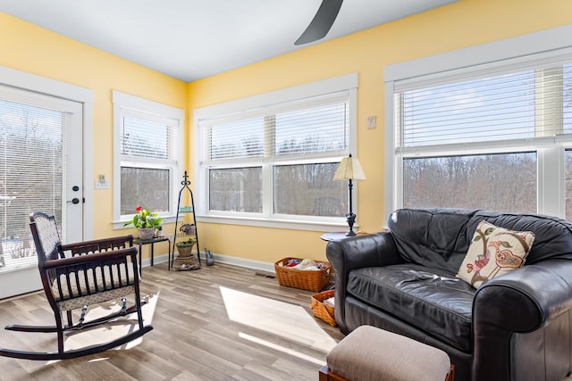 sunroom / solarium featuring ceiling fan and visible vents