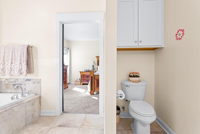 full bathroom with a bath, tile patterned flooring, toilet, and baseboards