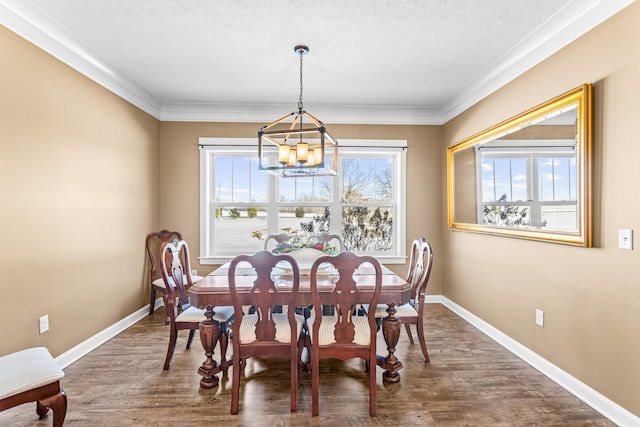 dining room with a textured ceiling, dark wood-type flooring, an inviting chandelier, and baseboards