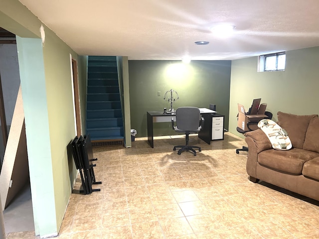 office area with baseboards and a textured ceiling