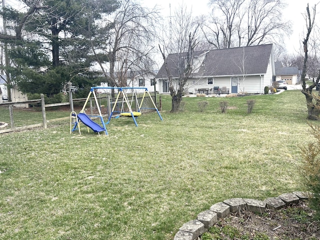 view of yard with fence and a playground