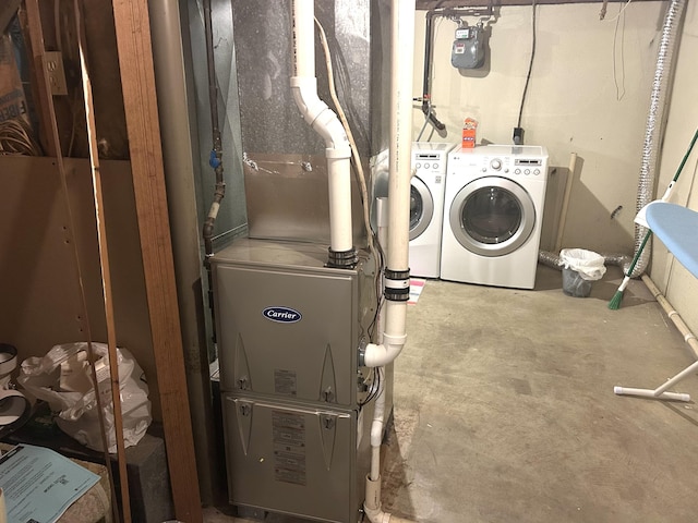 washroom with washing machine and dryer and laundry area