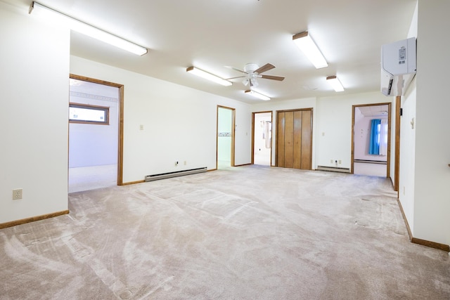 7868 Beech Ave, Russells Point, OH 43348 - empty room with an AC wall unit, baseboard heating, light colored carpet, ceiling fan, and baseboards