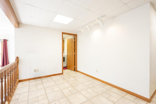 7868 Beech Ave, Russells Point, OH 43348 - unfurnished room with track lighting, baseboards, and washer / dryer