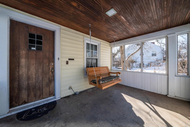 unfurnished sunroom featuring wood ceiling