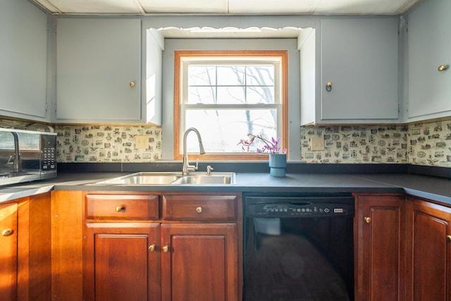 kitchen featuring black appliances, dark countertops, a sink, and brown cabinets