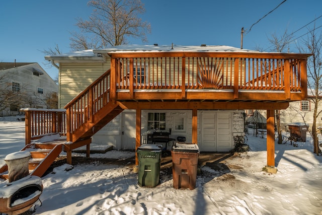 snow covered house featuring a deck