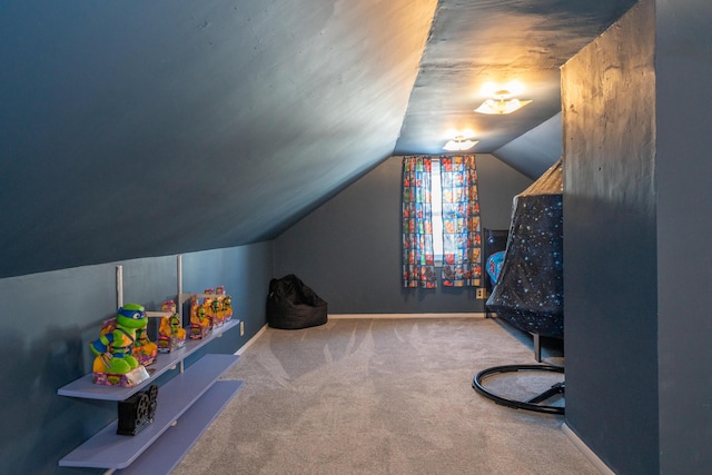 recreation room featuring carpet flooring, vaulted ceiling, and baseboards