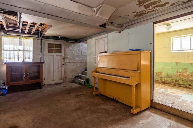 basement with stairway and concrete block wall