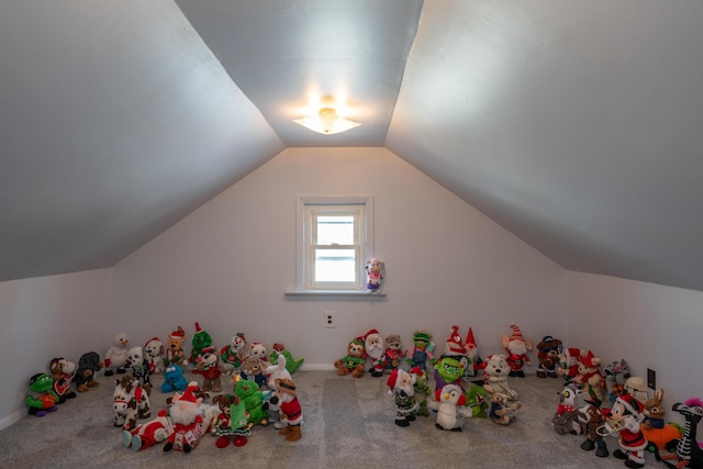 playroom with vaulted ceiling and carpet flooring