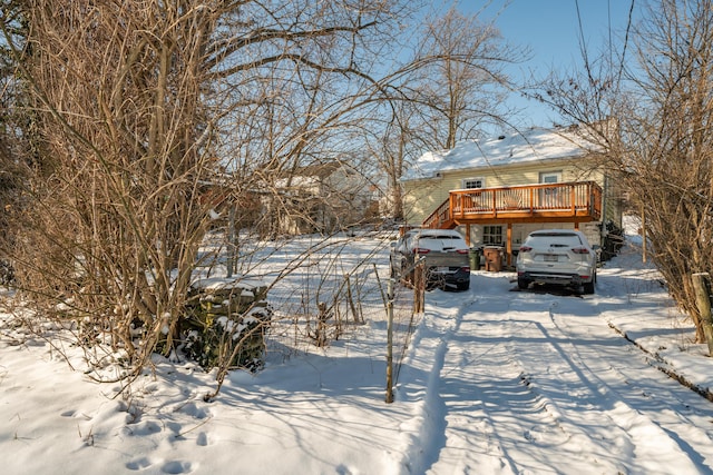 yard layered in snow featuring a wooden deck