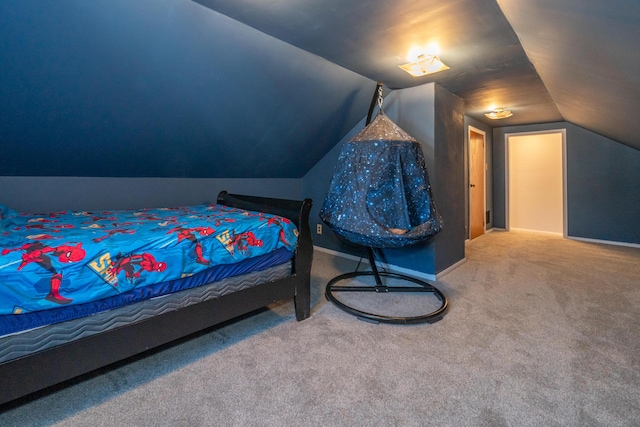 bedroom with vaulted ceiling and carpet flooring