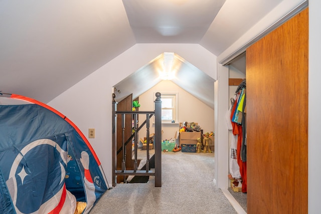 interior space with lofted ceiling and carpet flooring