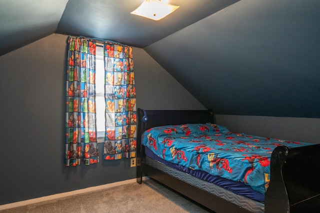 carpeted bedroom featuring vaulted ceiling and baseboards