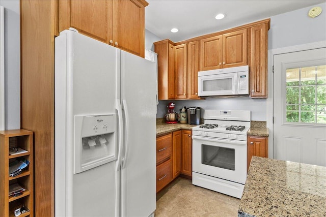402 E Baird St, West Liberty, OH 43357 - kitchen featuring white appliances, light stone countertops, brown cabinetry, and recessed lighting