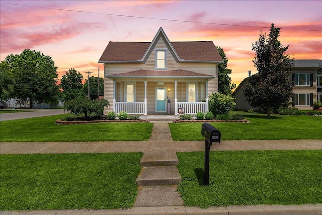 402 E Baird St, West Liberty, OH 43357 - view of front facade with covered porch and a yard